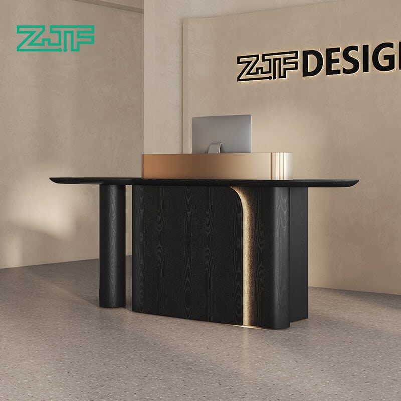 Black wood reception counter with strong gold contrast